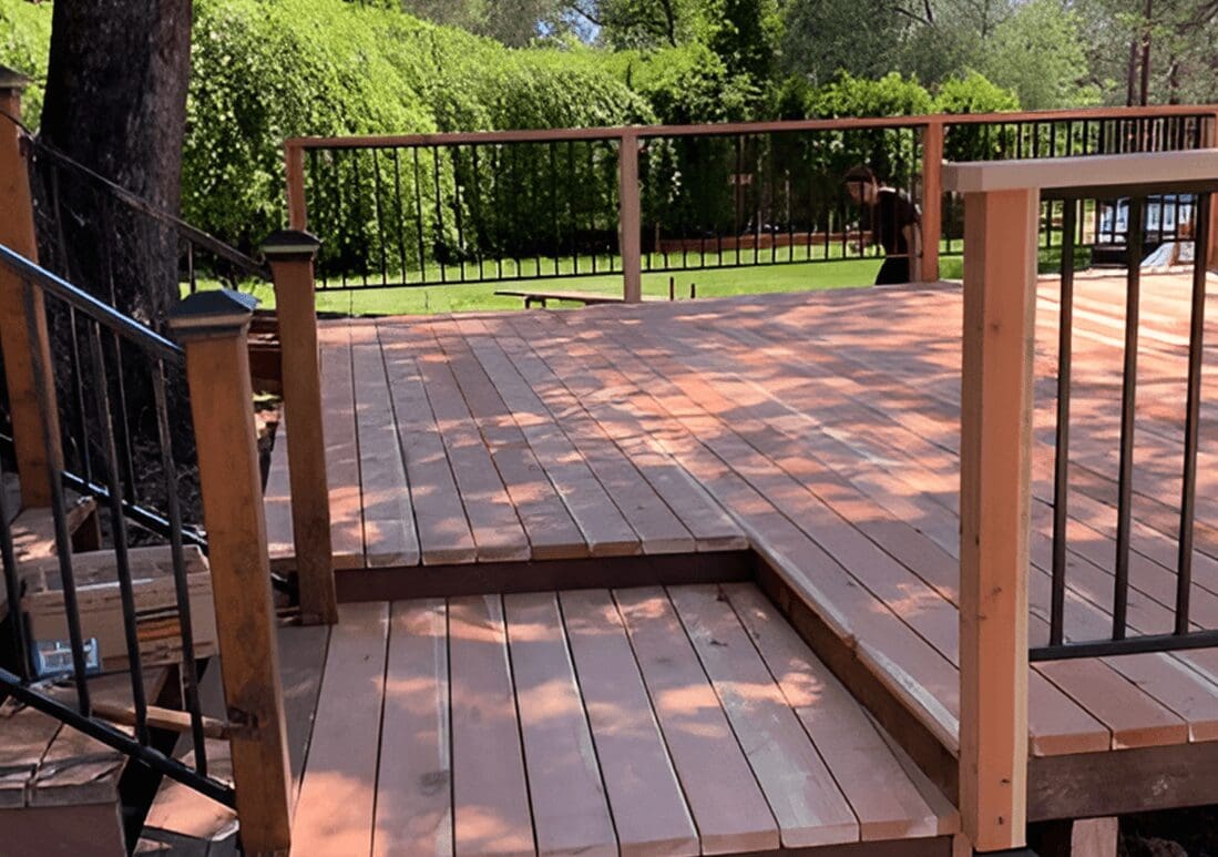 A wooden deck with steps leading to the top.