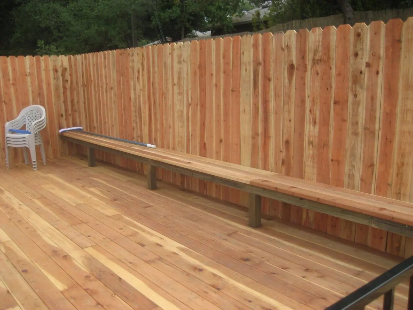 A wooden fence with benches on top of it.