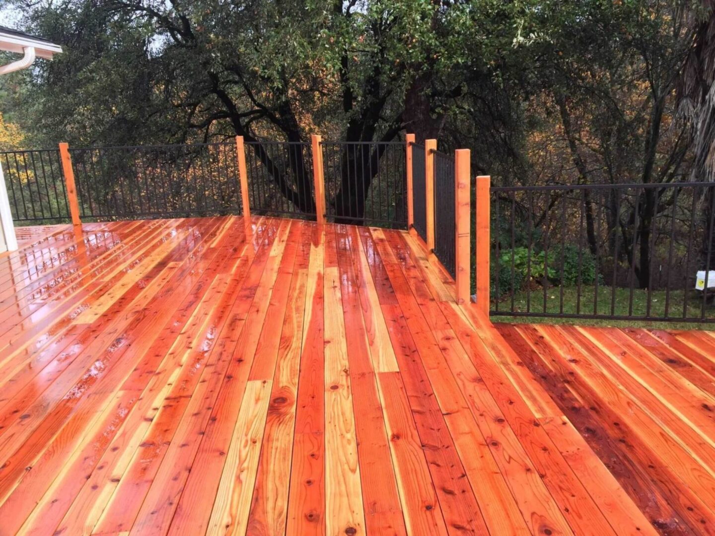 A wooden deck with trees in the background